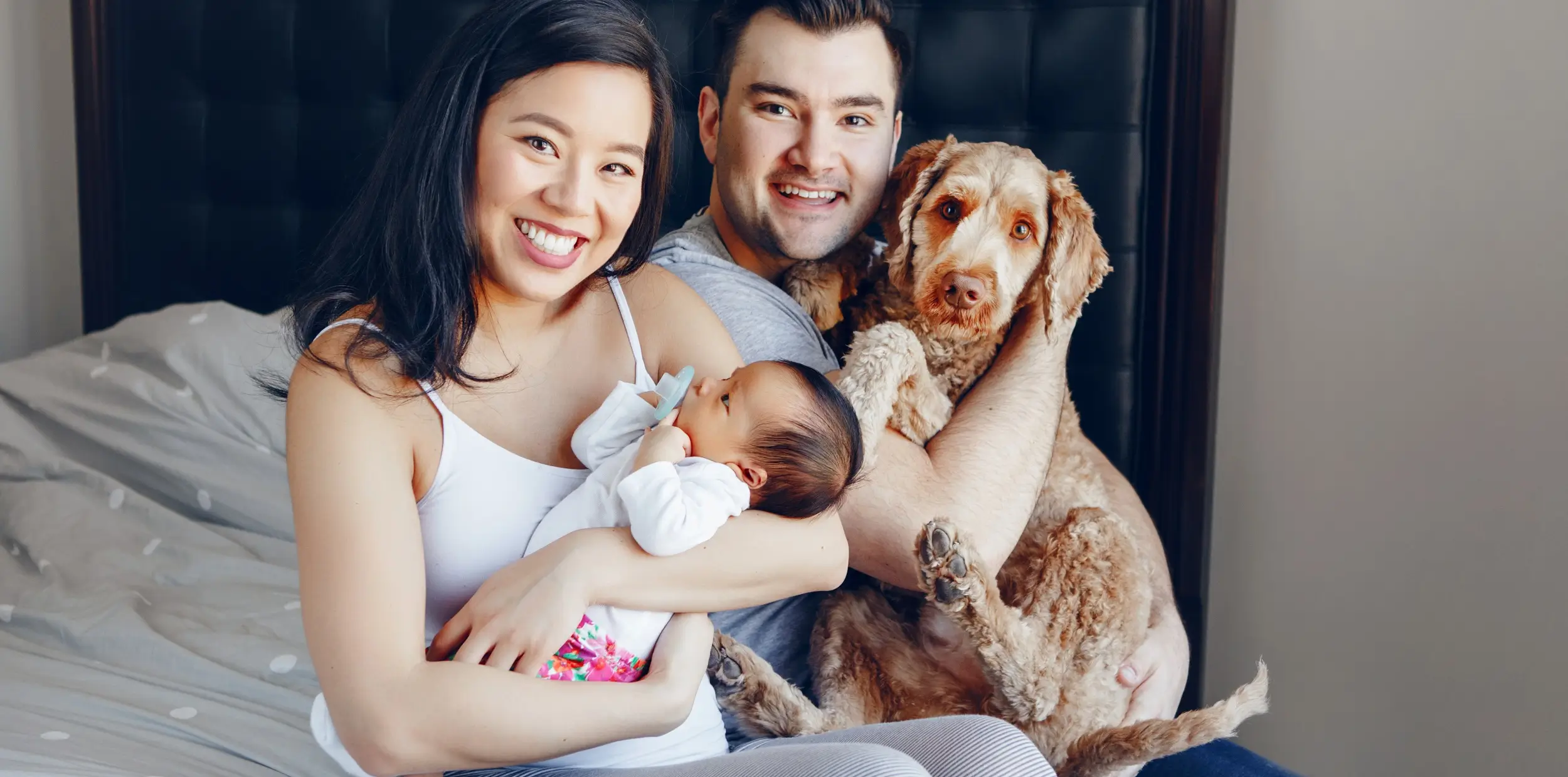 Happy Asian family with newborn baby and dog - My Asian Nanny service
